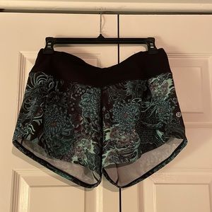 Size 6 Lululemon 4 inch green and black flowered patterned shorts